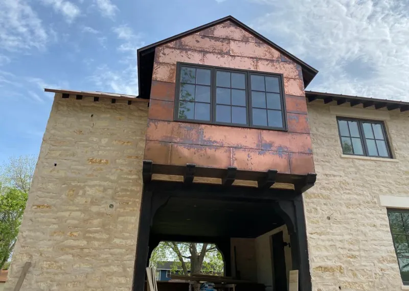 Copper metal panel facade on a stone building for Skylight Installation in North Branford